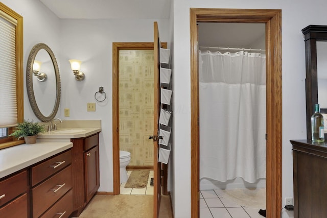 full bath with curtained shower, vanity, toilet, and tile patterned floors