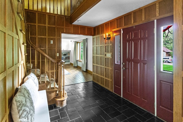 671 Carriage Ct, Newark, OH 43055 - foyer featuring wooden walls, baseboards, and stairs
