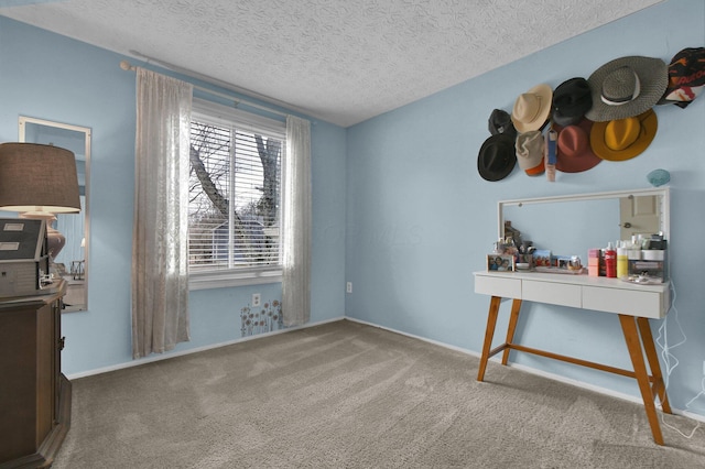 interior space featuring a textured ceiling and baseboards