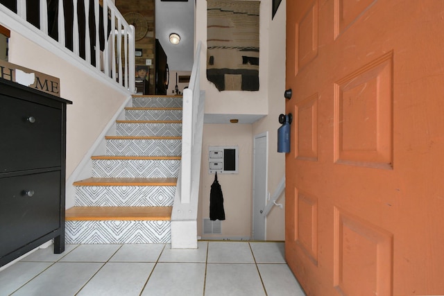 staircase with tile patterned floors