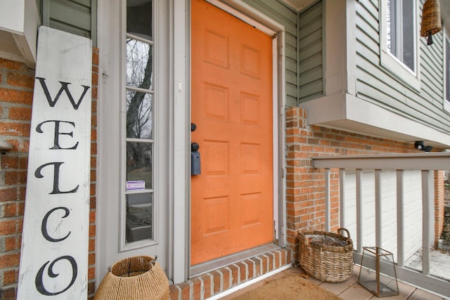 view of exterior entry with brick siding