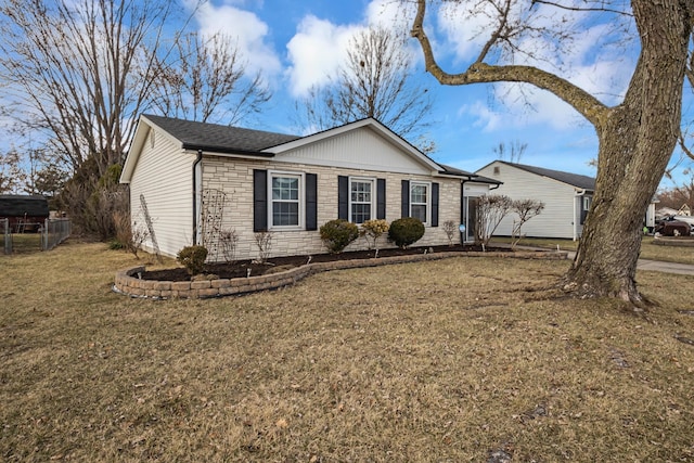 ranch-style house with stone siding and a front yard