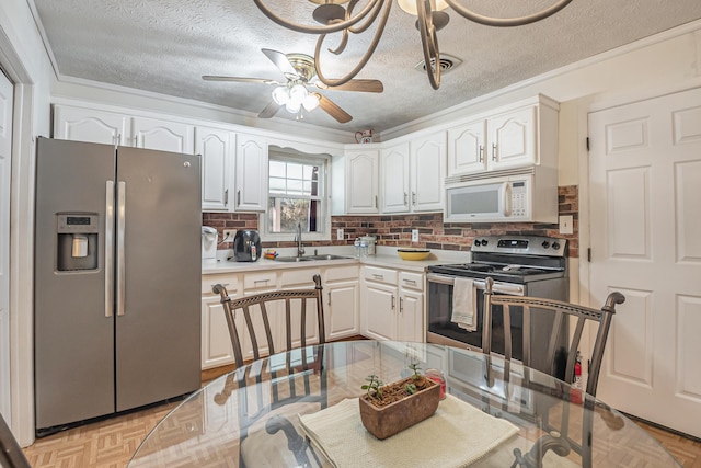 kitchen featuring a sink, a textured ceiling, white cabinetry, appliances with stainless steel finishes, and light countertops