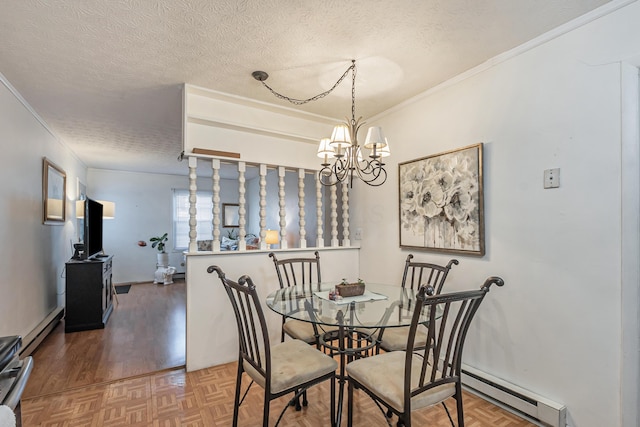 dining space with a chandelier, crown molding, a textured ceiling, and a baseboard heating unit