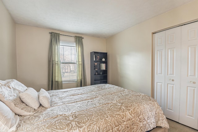 carpeted bedroom with a closet and a textured ceiling