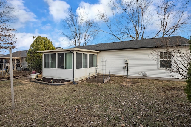 rear view of property with a sunroom