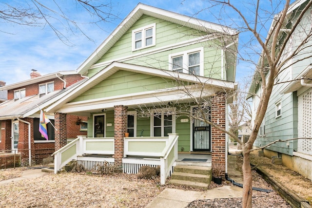 view of front of property with covered porch and brick siding