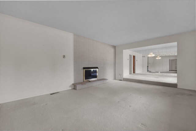 957 Sharon View Dr, Newark, OH 43055 - unfurnished living room featuring a fireplace, carpet, a chandelier, and baseboards