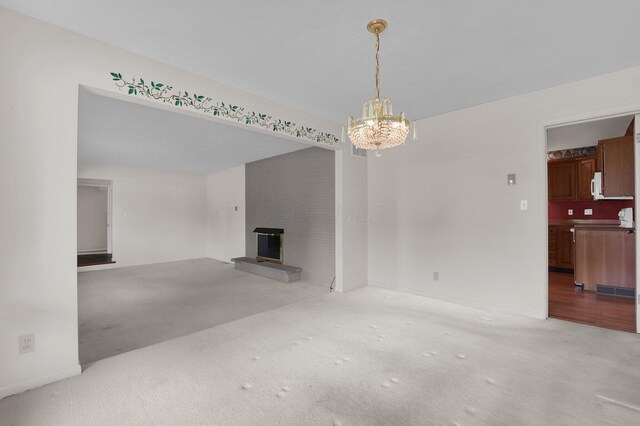 957 Sharon View Dr, Newark, OH 43055 - unfurnished living room featuring a brick fireplace, a chandelier, and carpet