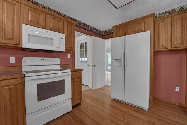 957 Sharon View Dr, Newark, OH 43055 - kitchen with white appliances, light wood-style floors, brown cabinetry, and light countertops