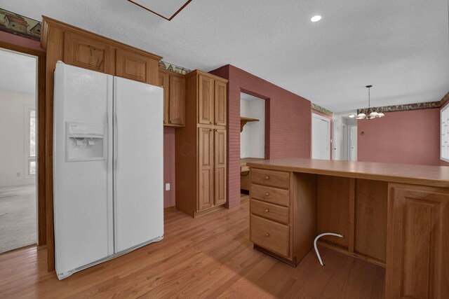 957 Sharon View Dr, Newark, OH 43055 - kitchen featuring white fridge with ice dispenser, light wood-style floors, a chandelier, brown cabinets, and a textured ceiling
