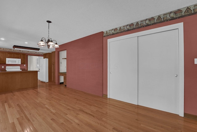 957 Sharon View Dr, Newark, OH 43055 - unfurnished living room with a chandelier, light wood-style floors, and recessed lighting