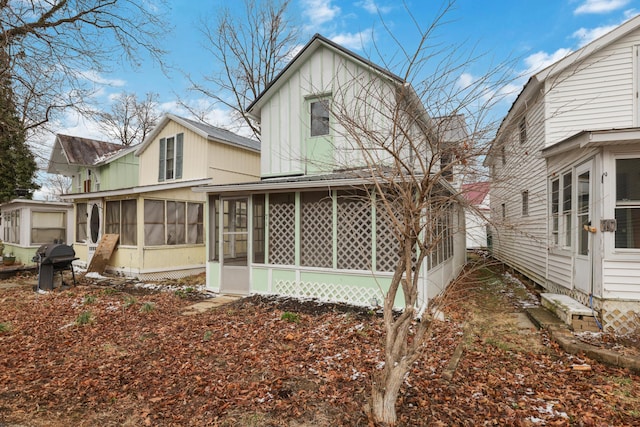 rear view of property with a sunroom