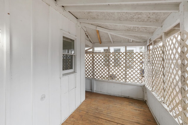 exterior space featuring plenty of natural light and lofted ceiling with beams