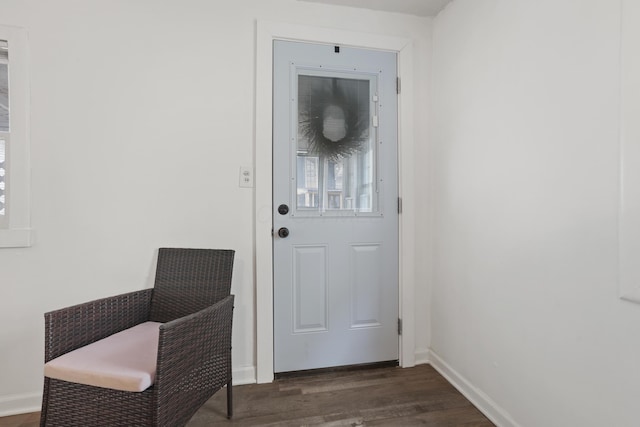 interior space with dark wood-type flooring and baseboards