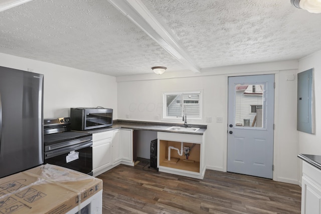 kitchen featuring dark wood-type flooring, a sink, white cabinets, appliances with stainless steel finishes, and electric panel