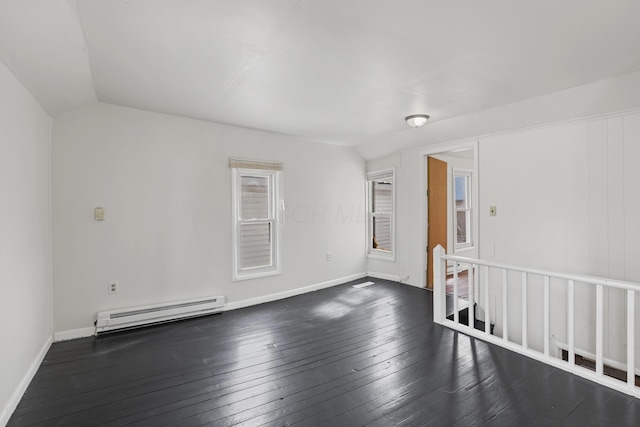 unfurnished room with lofted ceiling, baseboards, baseboard heating, and dark wood-style flooring