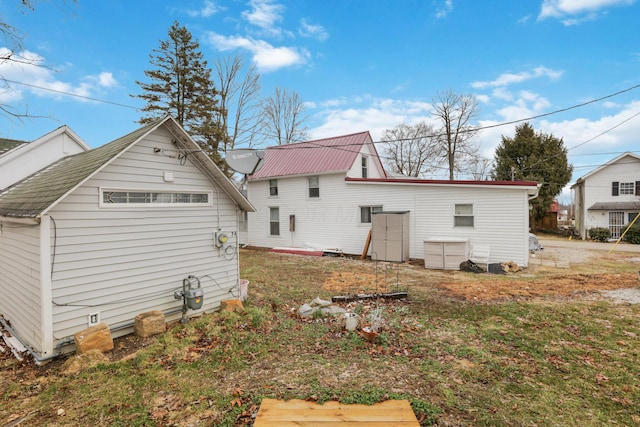 rear view of house featuring metal roof