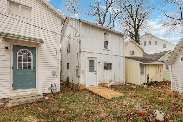 rear view of property featuring board and batten siding