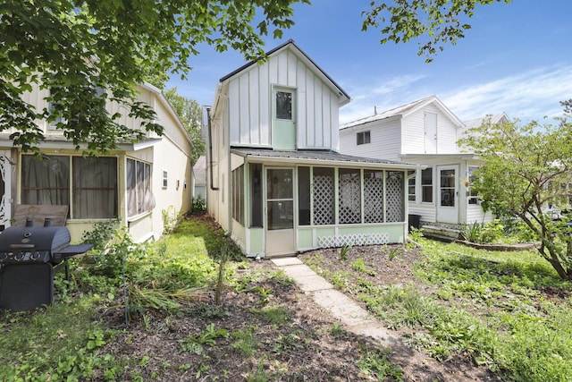 71 3rd St, Lancaster, OH 43130 - rear view of property featuring a sunroom, board and batten siding, and a metal roof