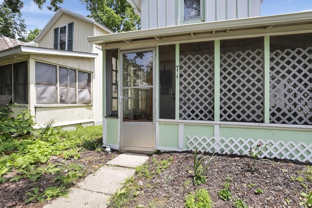 71 3rd St, Lancaster, OH 43130 - view of home's exterior with a sunroom and board and batten siding