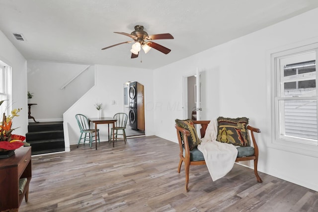 71 3rd St, Lancaster, OH 43130 - sitting room featuring stacked washer / dryer, arched walkways, a ceiling fan, stairs, and wood finished floors