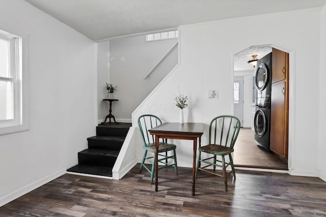 71 3rd St, Lancaster, OH 43130 - dining area with stacked washer / dryer, wood finished floors, stairs, and arched walkways