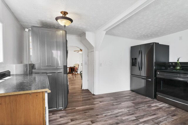 71 3rd St, Lancaster, OH 43130 - kitchen featuring stainless steel electric stove, a textured ceiling, fridge with ice dispenser, dark wood-style floors, and dark countertops