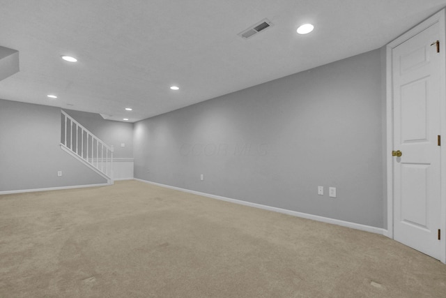 interior space with visible vents, baseboards, recessed lighting, stairs, and light colored carpet