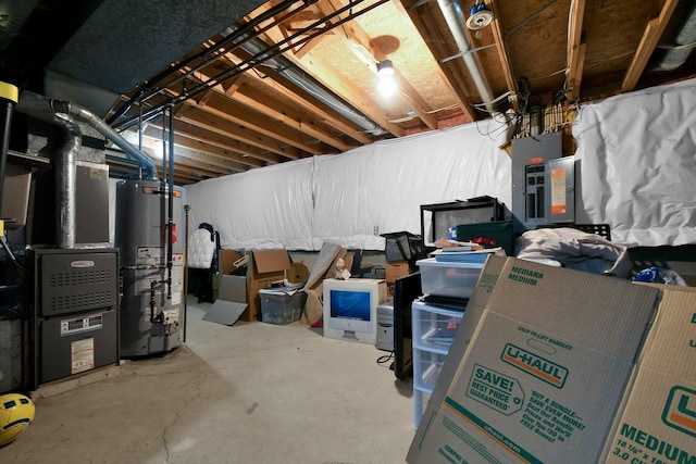 unfinished below grade area with gas water heater, heating unit, and electric panel