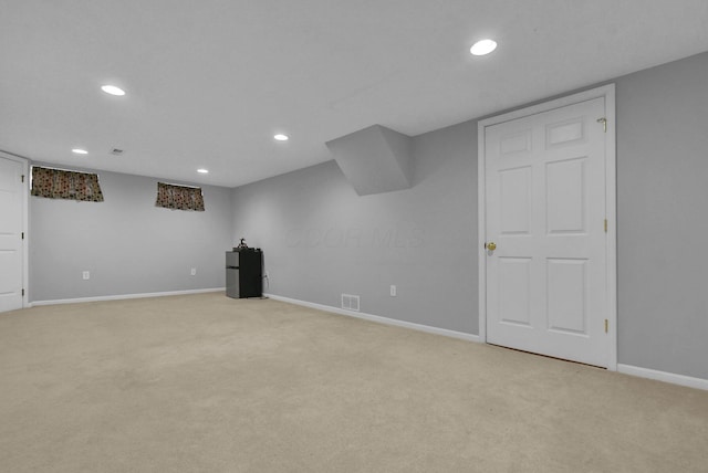 finished below grade area with recessed lighting, visible vents, and light carpet