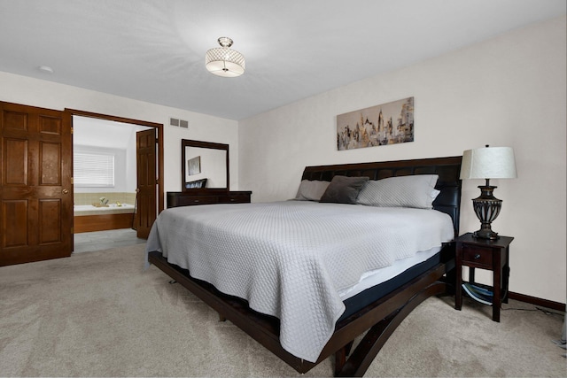 bedroom featuring ensuite bath, baseboards, visible vents, and light carpet