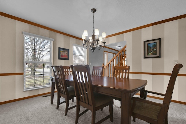 dining space with carpet floors, crown molding, baseboards, a chandelier, and stairs