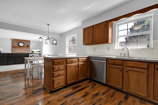 kitchen featuring brown cabinetry, a sink, and stainless steel dishwasher