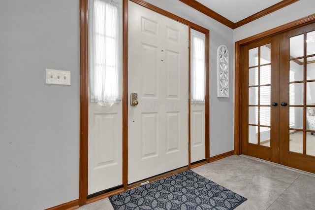 entrance foyer featuring french doors, baseboards, and ornamental molding