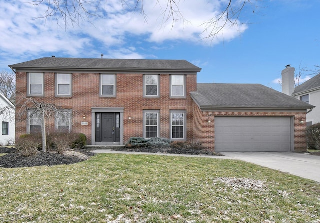 colonial-style house with a shingled roof, concrete driveway, a front yard, an attached garage, and brick siding