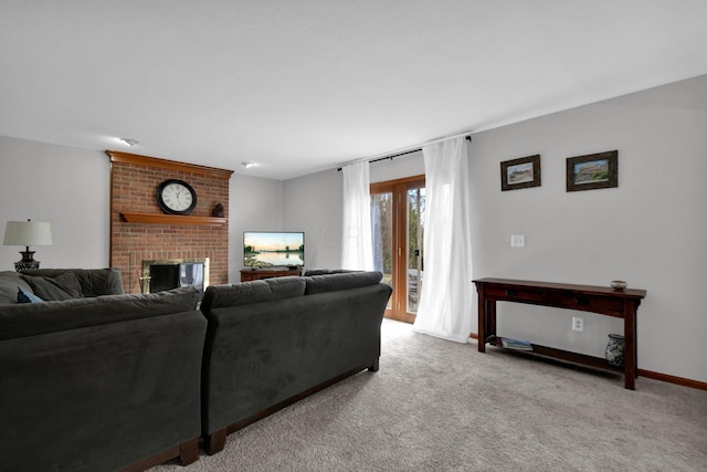 living room with a brick fireplace, carpet, and baseboards