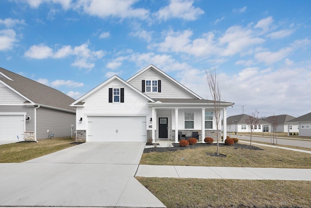 view of front facade featuring a porch, stone siding, driveway, and a front lawn