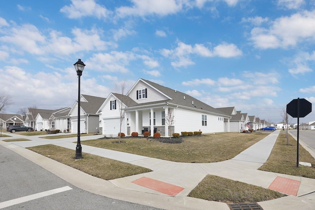 view of front of house with driveway, a residential view, and a porch