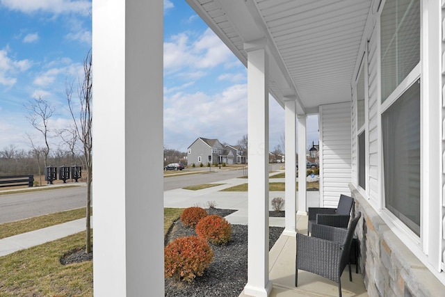 view of patio featuring a porch and a residential view