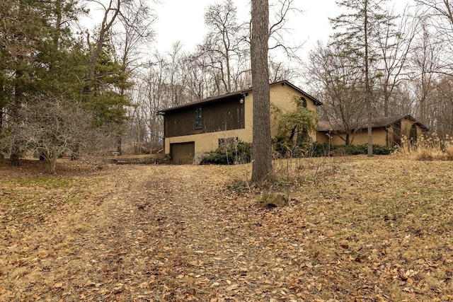 view of property exterior with an attached garage