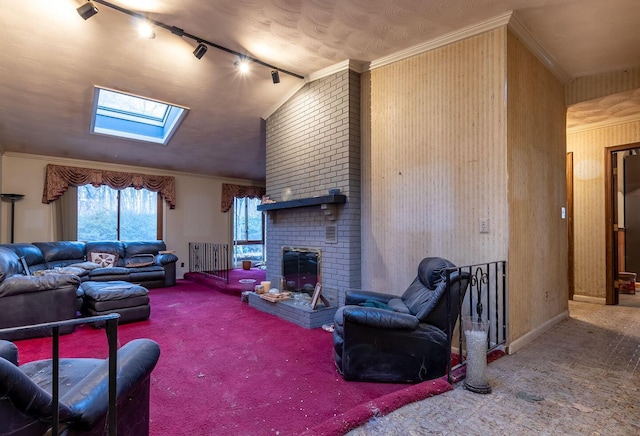 living area with ornamental molding, carpet, a fireplace, and lofted ceiling with skylight