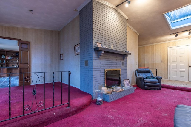 living room with a skylight, baseboards, carpet, crown molding, and a brick fireplace