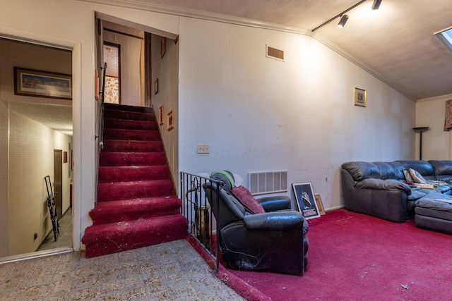 interior space with lofted ceiling, stairway, visible vents, and crown molding