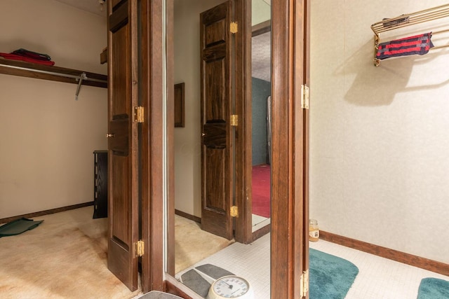 interior space with baseboards and light colored carpet