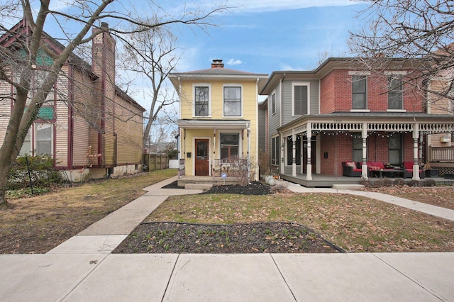 view of front of property with covered porch and a chimney