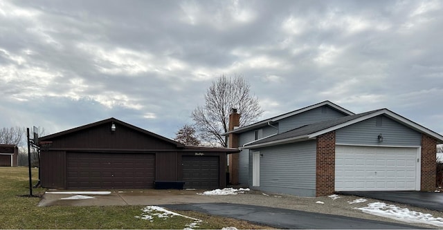 view of front of home with a garage and a chimney