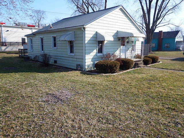 view of home's exterior with a lawn