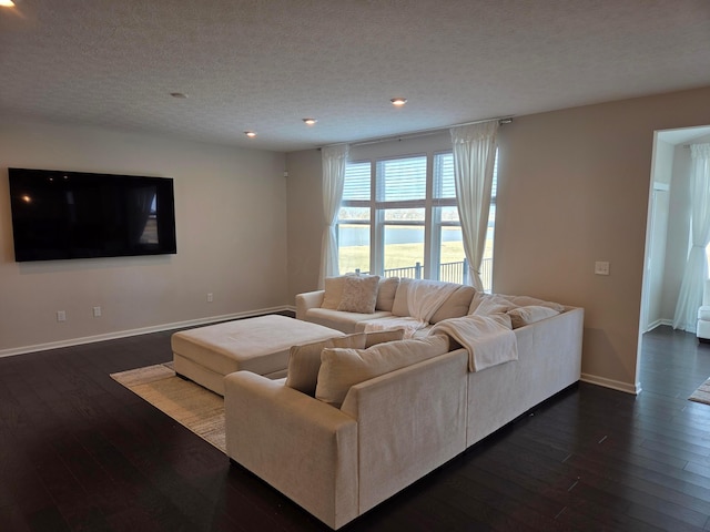 living room with dark wood-style floors, recessed lighting, a textured ceiling, and baseboards