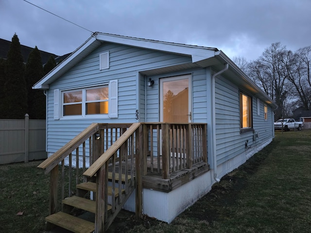 view of front of property with a front yard and fence